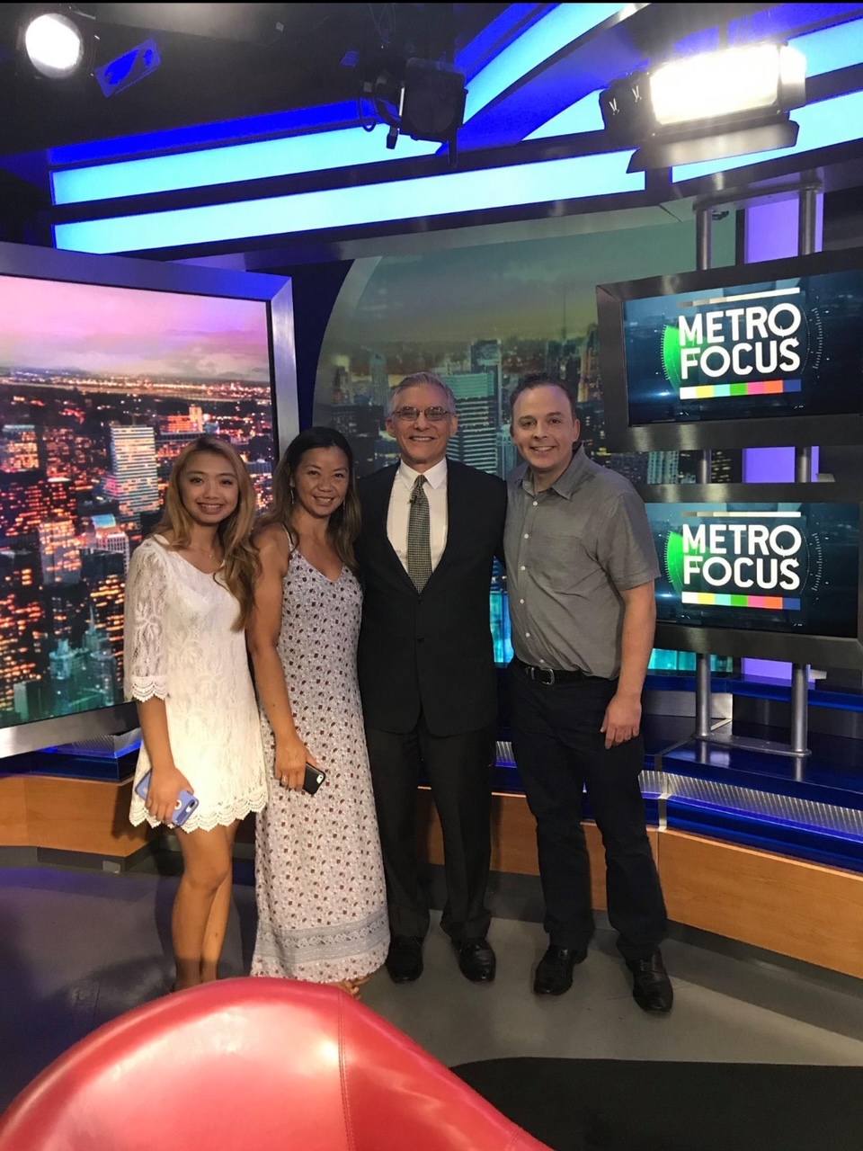 A group of people standing in front of a tv.